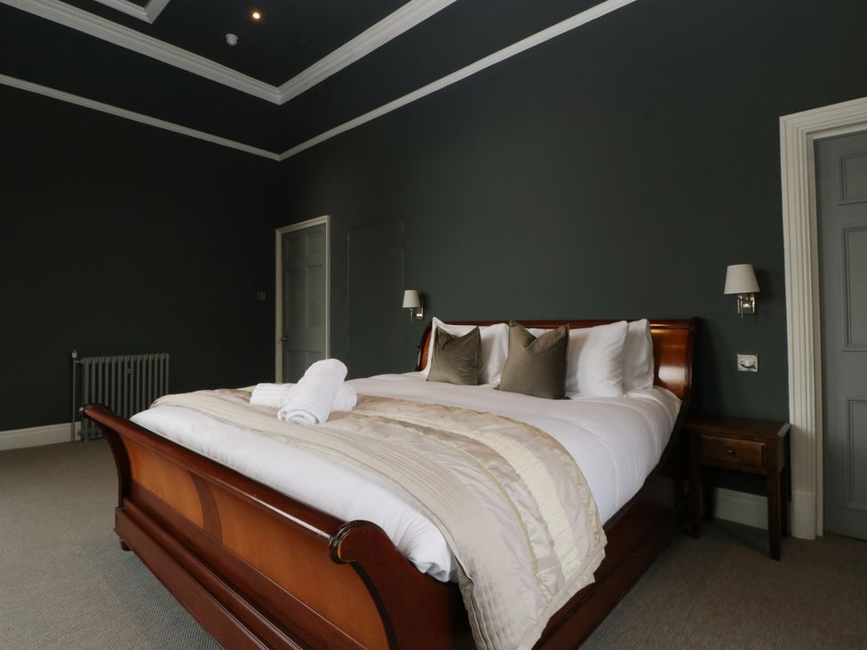 A bedroom with a bed and a bedside table at Frenchay Park House in Bristol