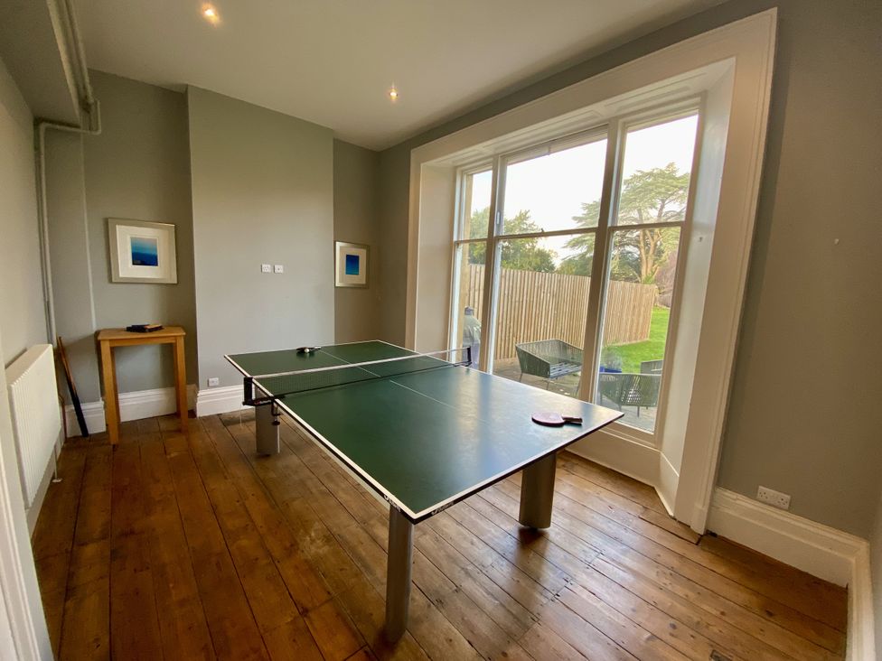 A games room with a table tennis table and a painting at Frenchay Park House in Bristol