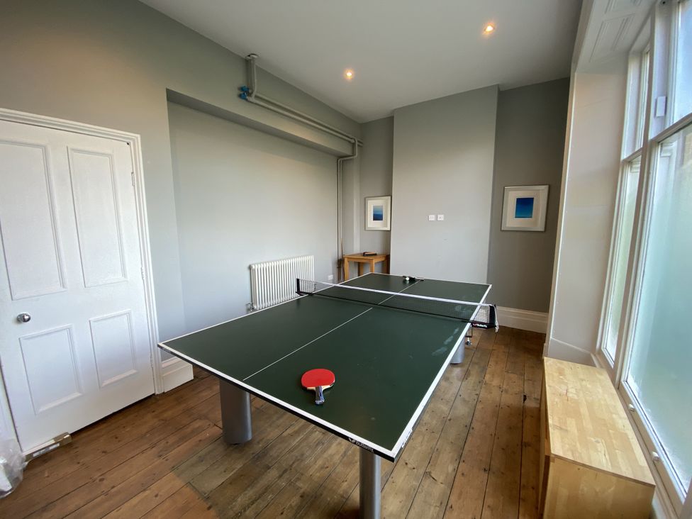 A game room with a table tennis table and a radiator at Frenchay Park House Bristol