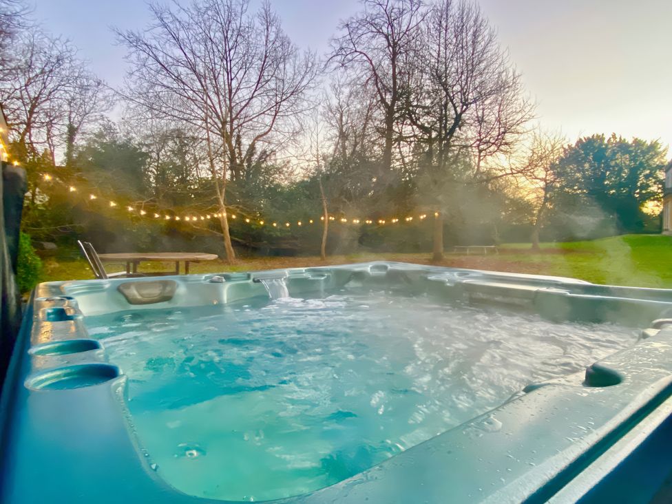 A hot tub with steam and lights in the garden at Frenchay Park House Bristol