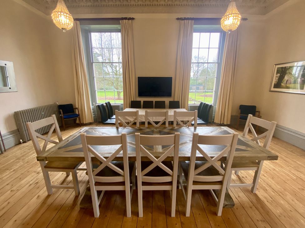A dining room with a table and chairs at Frenchay Park House in Bristol
