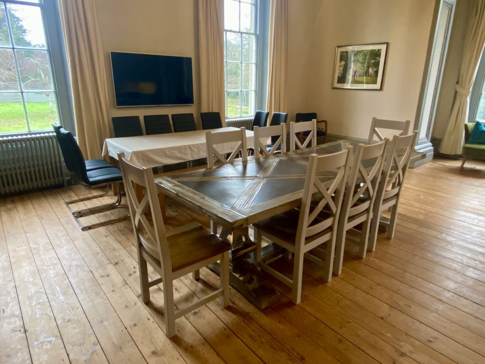 A dining room with a table and chairs at Frenchay Park House in Bristol