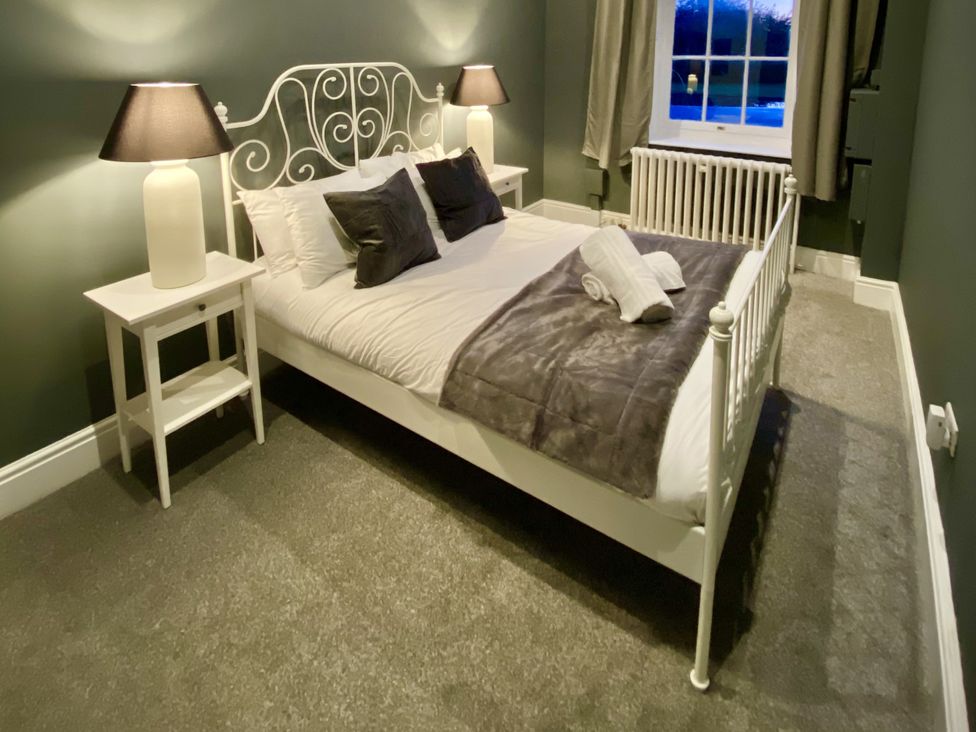 A bedroom with a bed and bedside tables at Frenchay Park House in Bristol