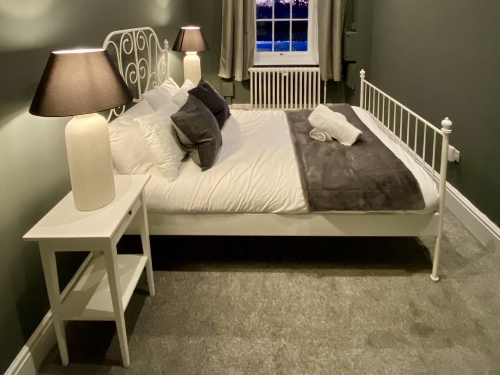 A bedroom with a bed and nightstand at Frenchay Park House in Bristol