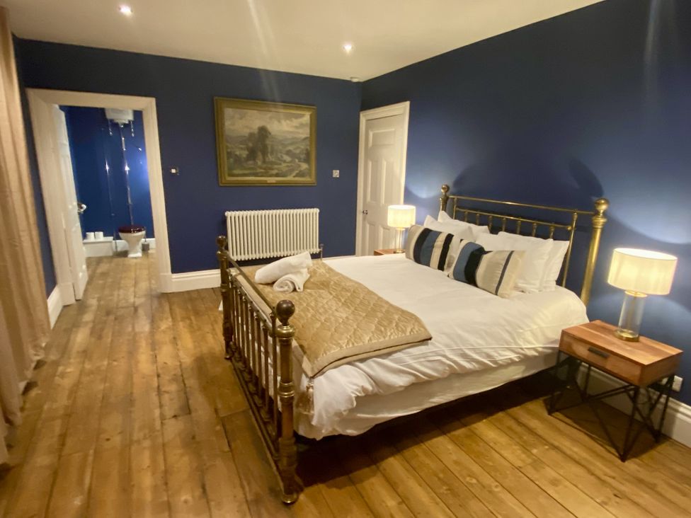 A bedroom with a bed and nightstands at Frenchay Park House, Bristol