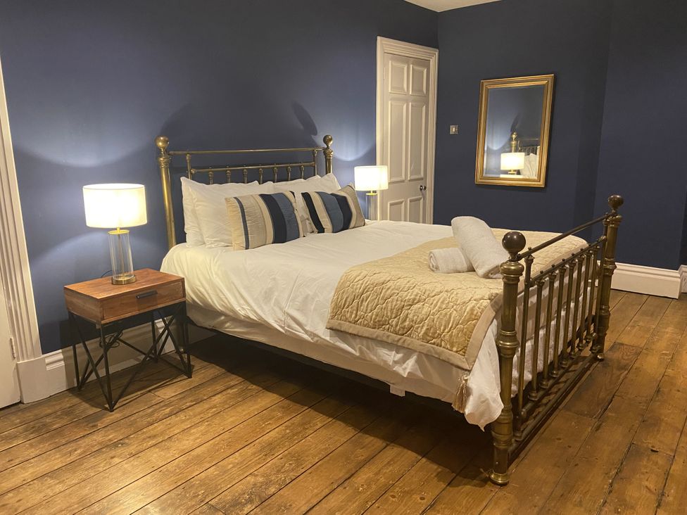A bedroom with a bed and a bedside lamp at Frenchay Park House in Bristol