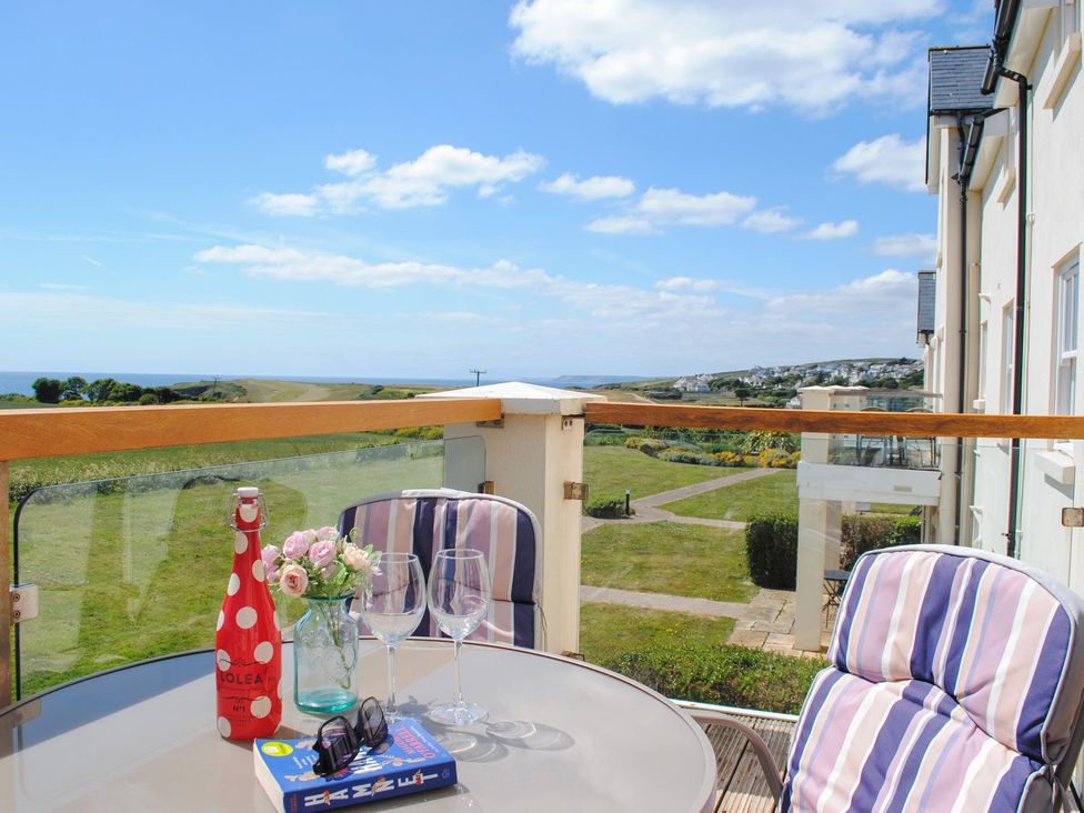 A balcony with a table and glasses at 8 Thurlestone Beach in Kingsbridge
