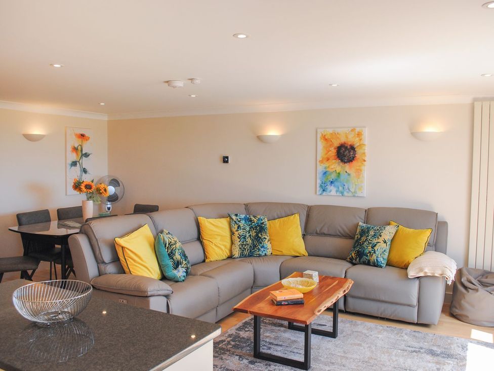 A living room with a sofa and coffee table at 8 Thurlestone Beach in Kingsbridge