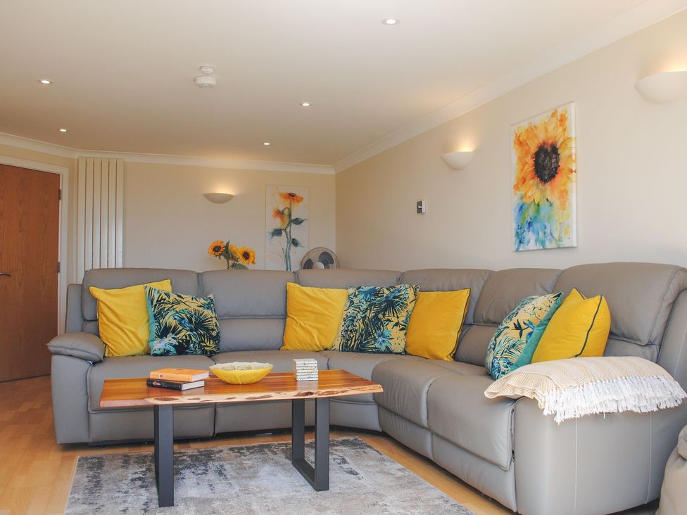 A living room with a sofa and coffee table at 8 Thurlestone Beach in Kingsbridge