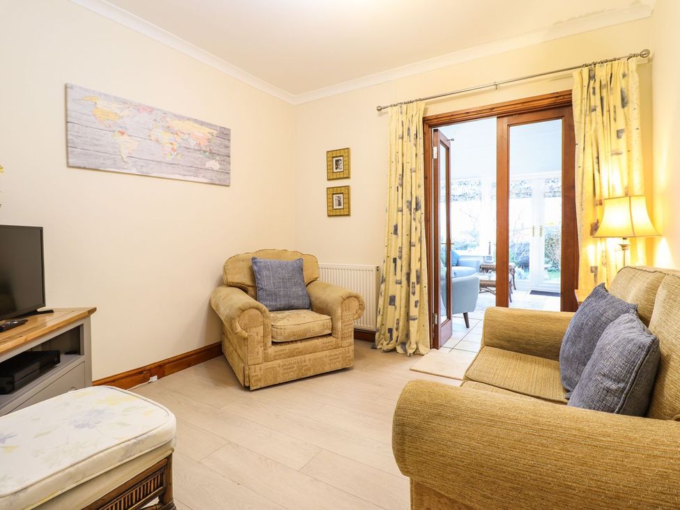 A living room with a sofa and armchair at Llwyn Derw in Talybont