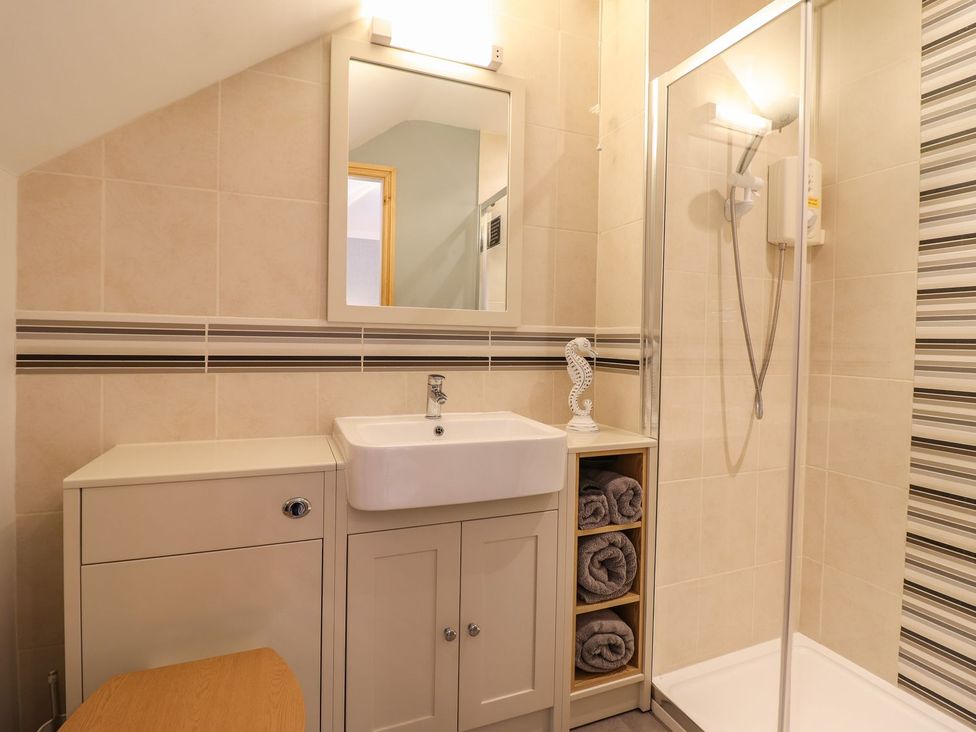 A bathroom with a sink and shower at Llwyn Derw in Talybont