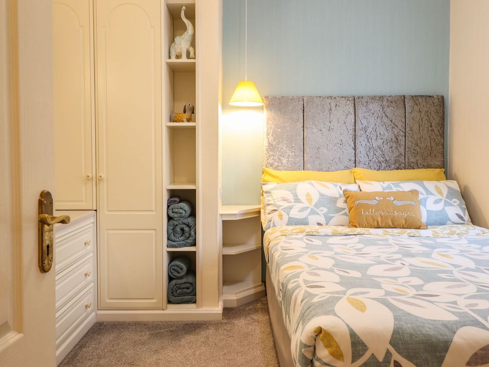 A bedroom with a bed and wardrobe at Llwyn Derw in Talybont