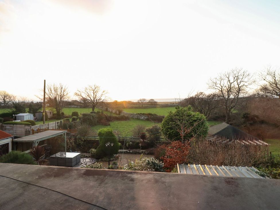 A view of fields and trees from a garden at Llwyn Derw in Talybont