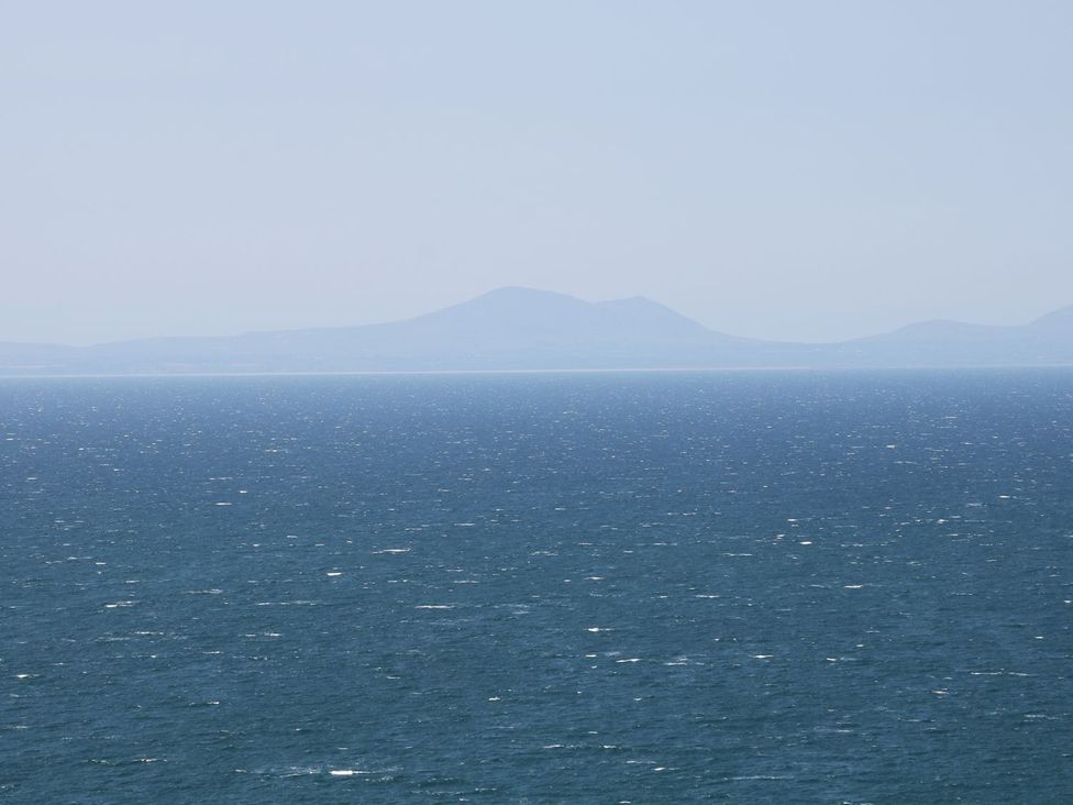A view of the sea and distant mountains at Llwyn Derw in Talybont