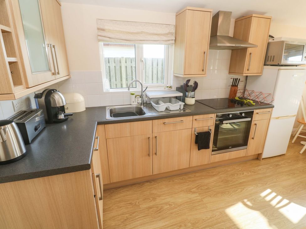 A kitchen with a sink and oven at Chalet 225 Tregolds near St Merryn
