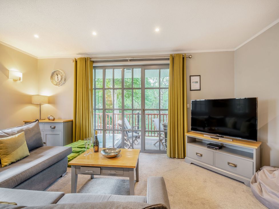 A living room with a sofa and TV at Ailsa Craig Spa in Dailly
