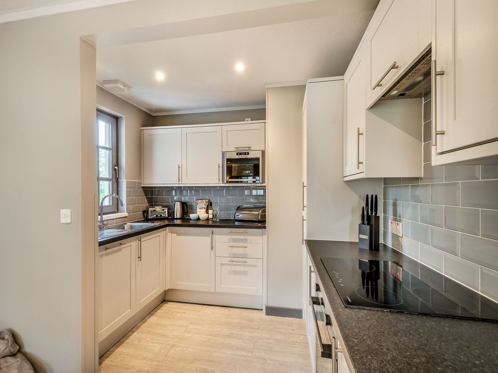 A kitchen with modern cabinets and appliances at Ailsa Craig Spa Dailly
