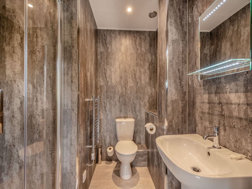 A bathroom with a sink, toilet and shower at Ailsa Craig Spa, Dailly