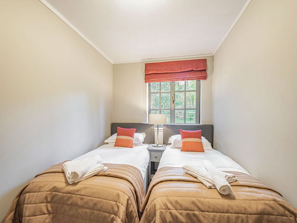 A bedroom with two single beds and a window at Ailsa Craig Spa in Dailly