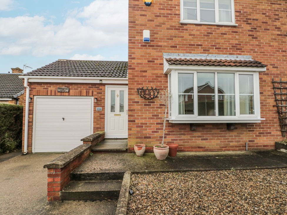 A house exterior with front door and garage at Thorntons House in Northallerton