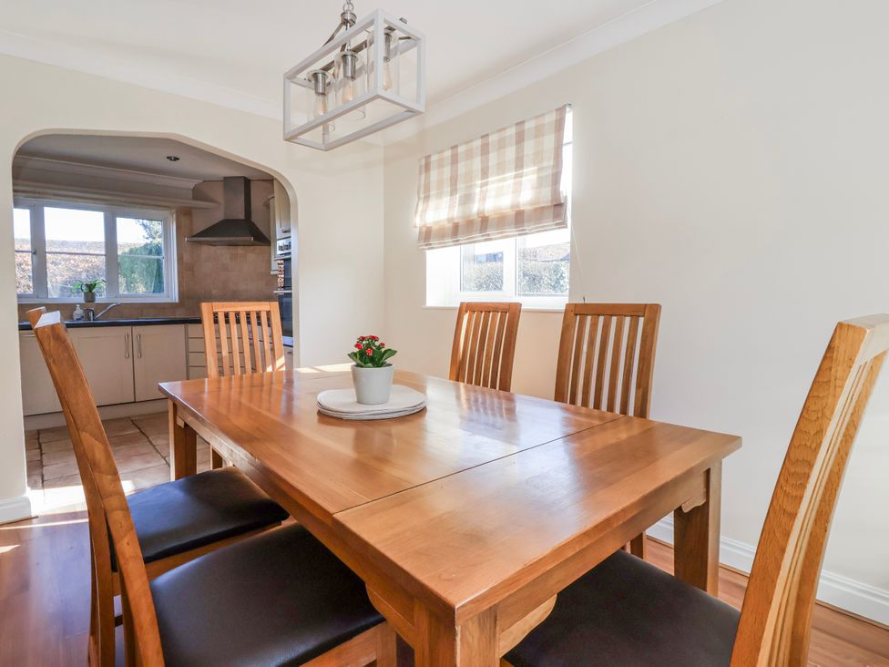A dining room with a table and chairs at Thorntons House in Morton-On-Swale