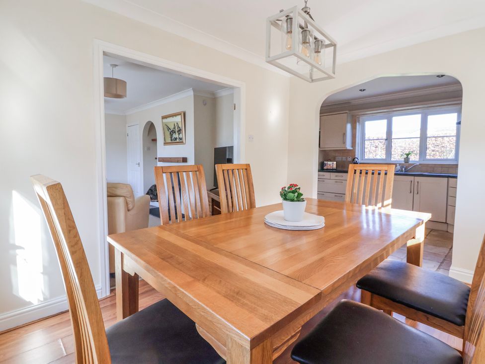 A dining room with a wooden table and chairs at Thorntons House Morton-On-Swale