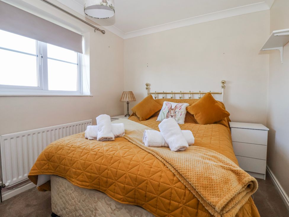 A bedroom with a bed and towels at Thorntons House in Morton-On-Swale