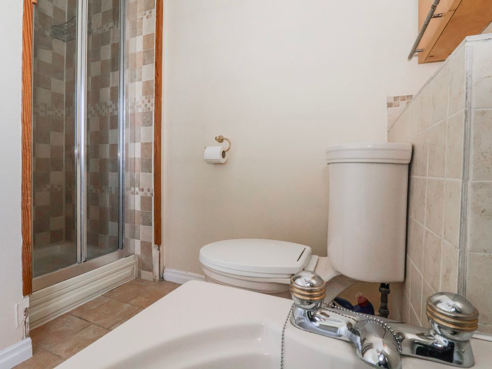 A bathroom with a shower and toilet at Thorntons House in Morton-On-Swale