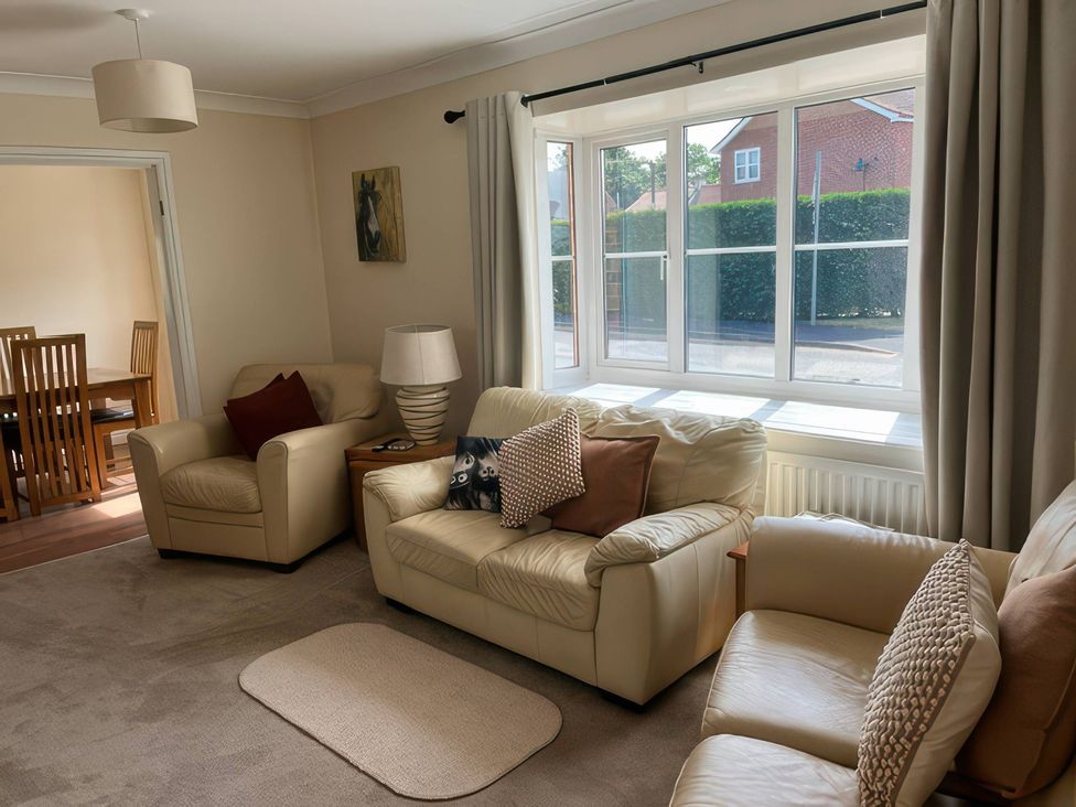 A living room with sofas and a lamp at Thorntons House in Morton-On-Swale