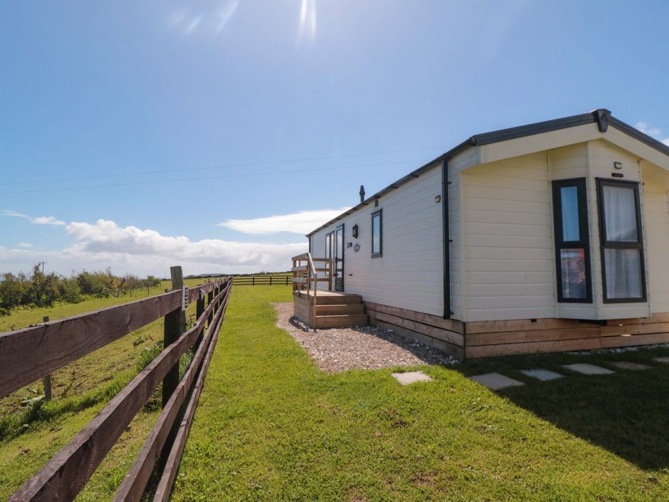 A cabin with a pathway in front at Rosefinch Cabin Staintondale near Scarborough