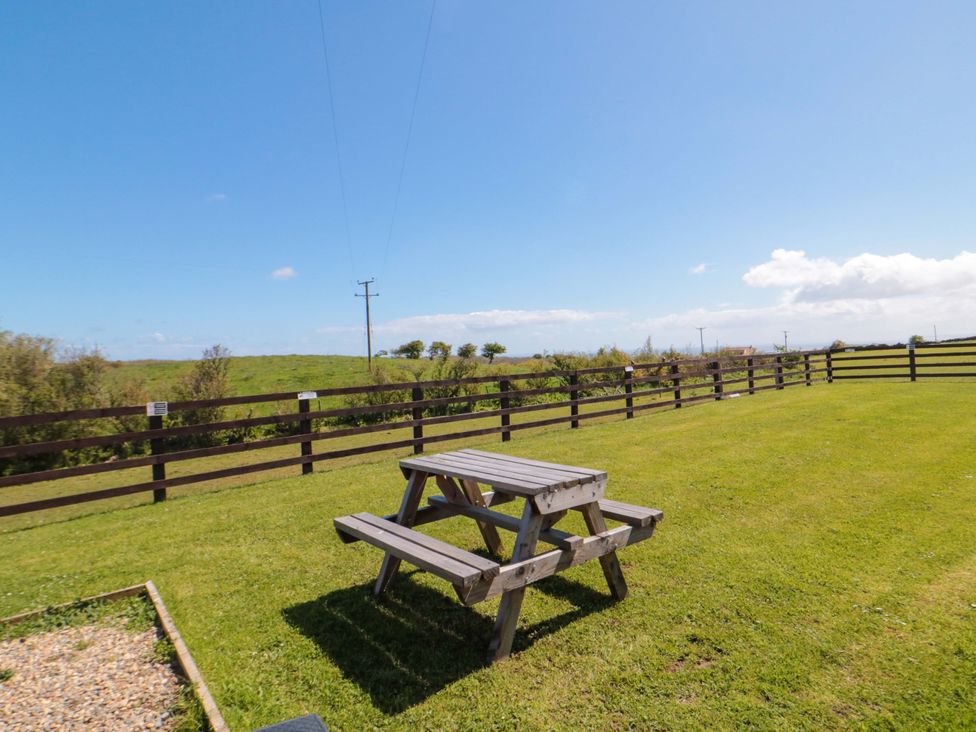 A picnic table on grass at Rosefinch Cabin Staintondale near Scarborough