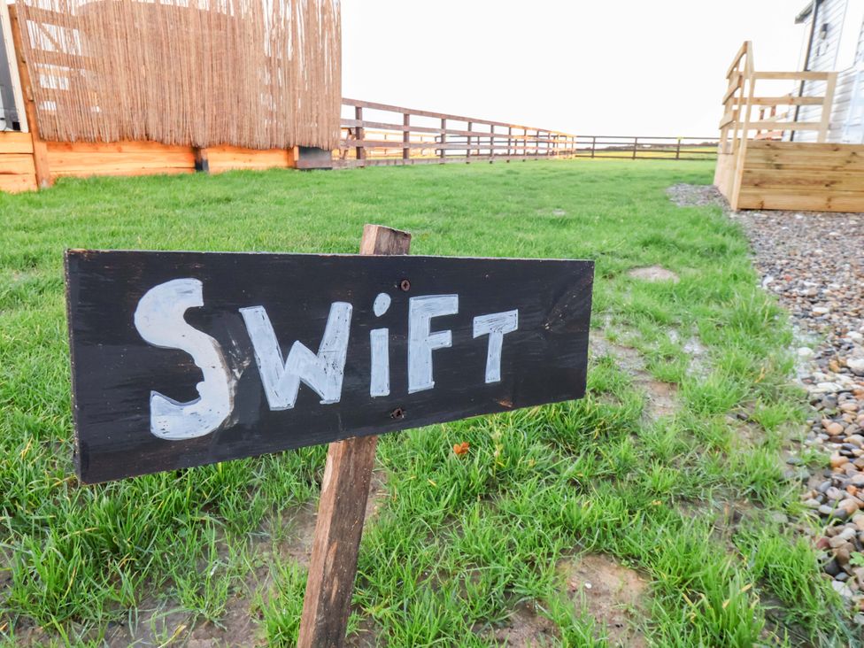 A sign labeled Swift in a grassy area at Swift Cabin in Scarborough