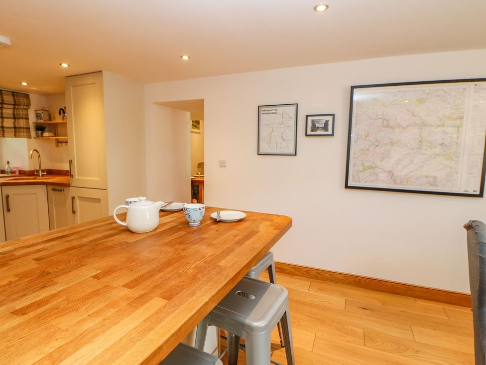 A kitchen with a table and teapot at Wayside Farm in Richmond
