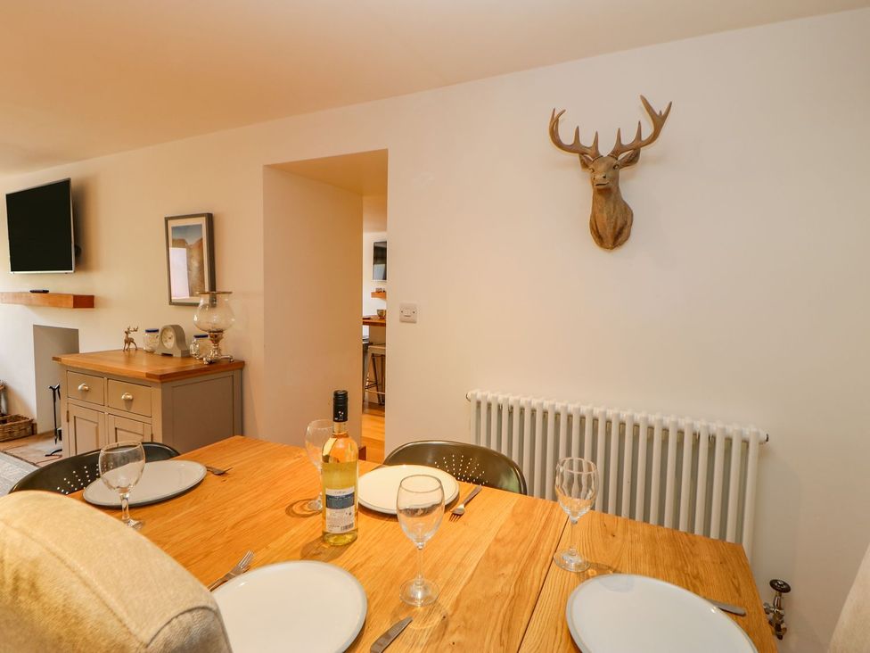 A dining room with a table set for meals at Wayside Farm in Richmond