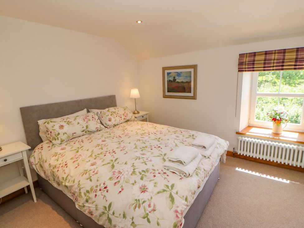 A bedroom with a bed and a window at Wayside Farm Richmond