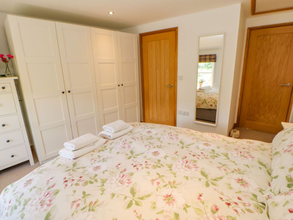 A bedroom with a bed and wardrobe at Wayside Farm in Richmond