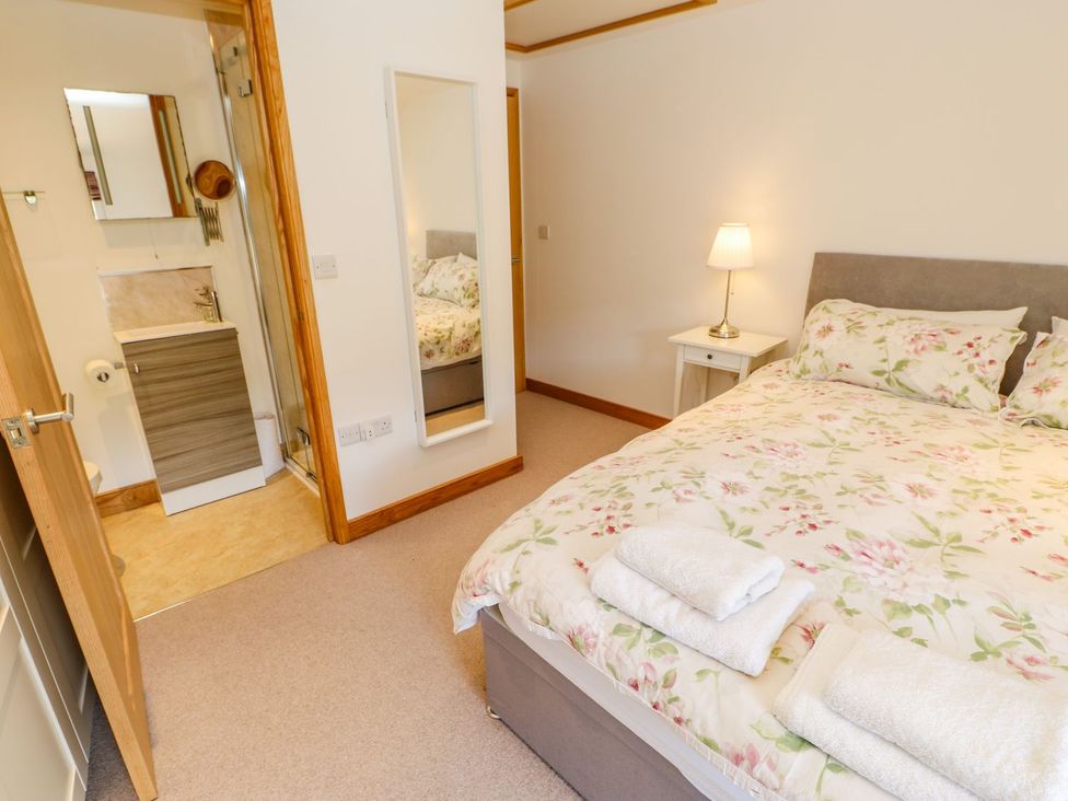 A bedroom with a bed and an en-suite bathroom at Wayside Farm Richmond