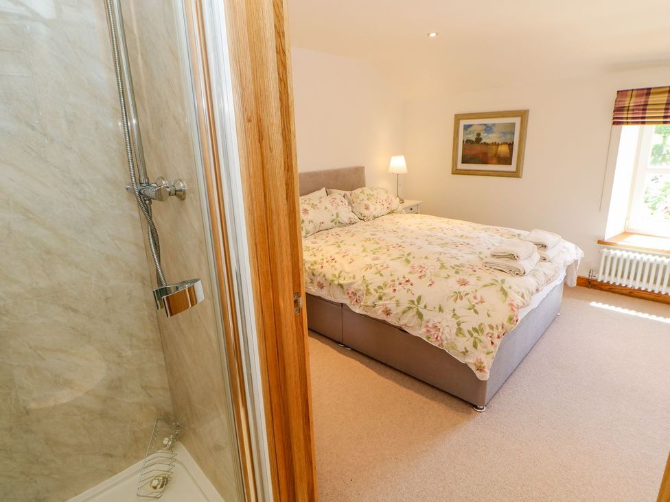 A bedroom with a bed and a shower at Wayside Farm in Richmond