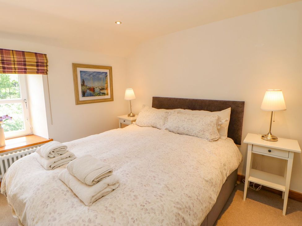 A bedroom with a bed and bedside tables at Wayside Farm in Richmond