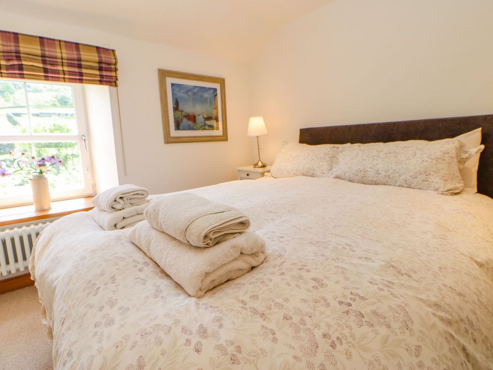 A bedroom with a bed and towels folded on it at Wayside Farm in Richmond