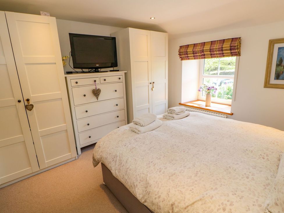 A bedroom with a bed and a television at Wayside Farm in Richmond