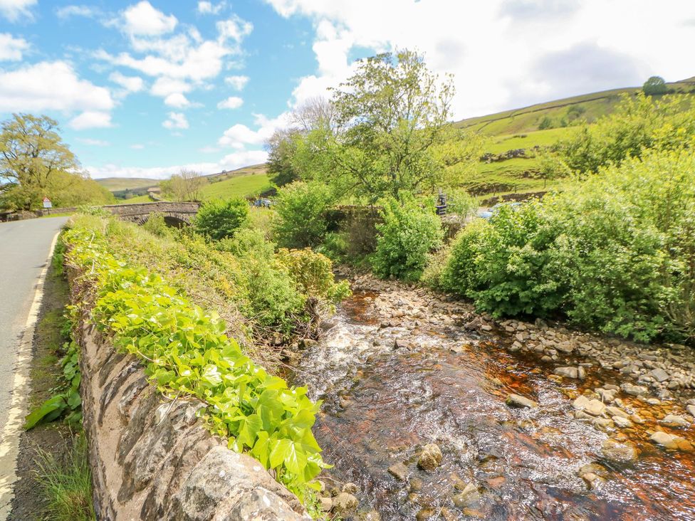 A stream alongside a road with greenery at Wayside Farm Richmond