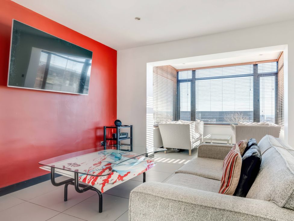 A living room with a television, coffee table, and seating at Bellevue