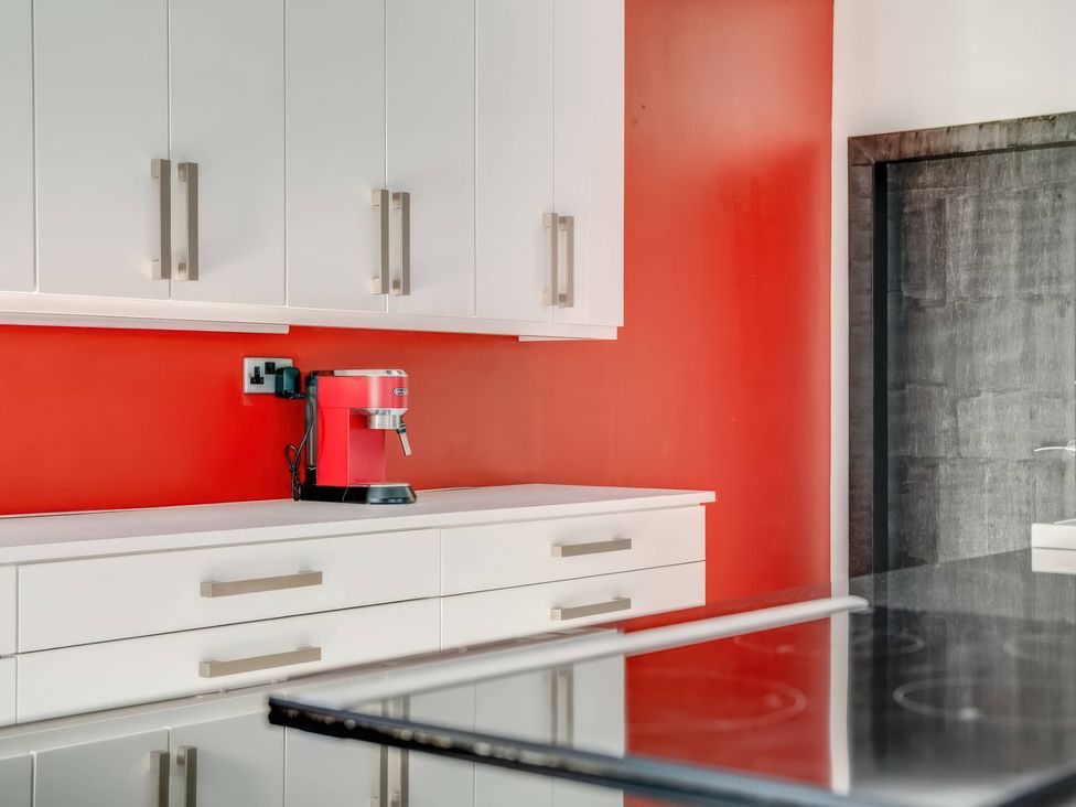 A kitchen with cabinets and a coffee machine at Bellevue