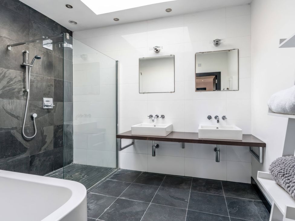 A bathroom with a bathtub and double sinks at Bellevue