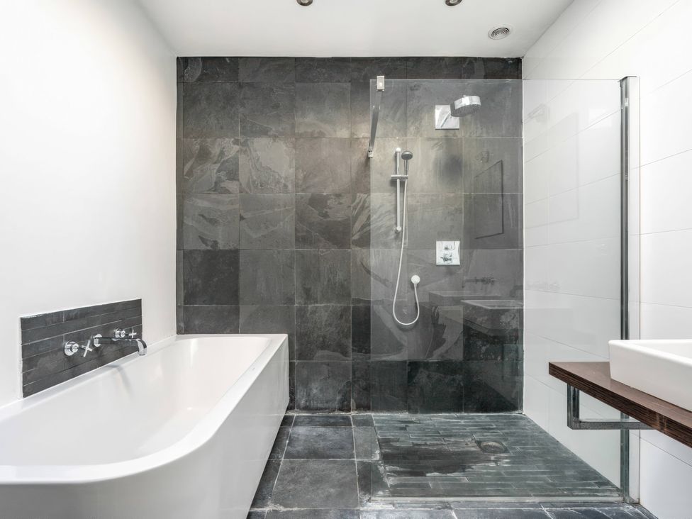 A bathroom with a shower and bathtub at Bellevue