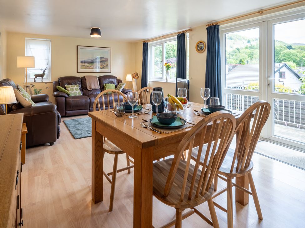 A dining room with a table and chairs at Oaks Lodge Cottage Ambleside