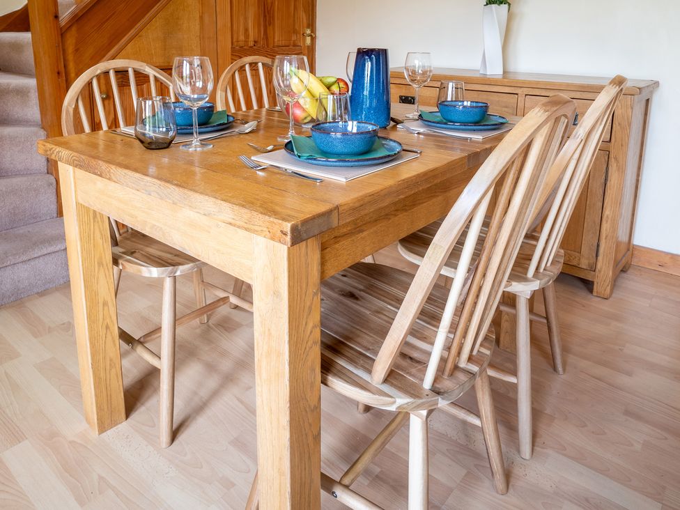 A dining room with a wooden table and chairs at Oaks Lodge Cottage in Ambleside