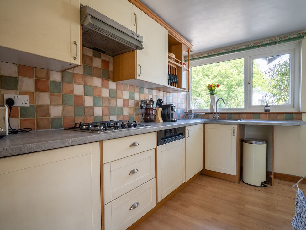 A kitchen with a gas stove and window at Oaks Lodge Cottage in Ambleside