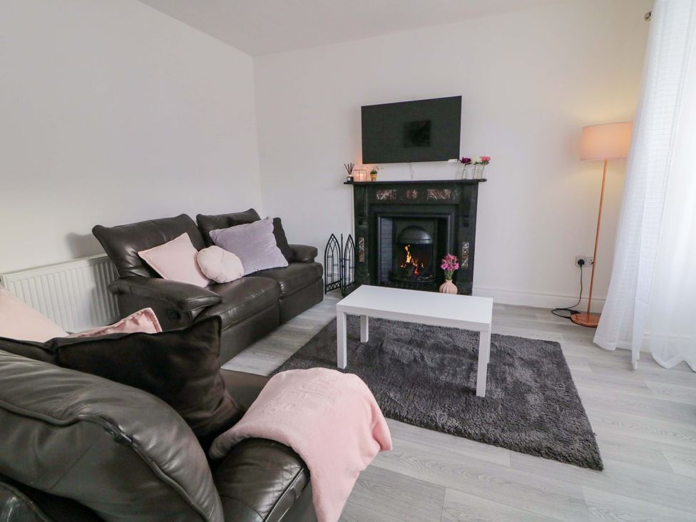 A living room with a sofa and a coffee table at San Antonio in Dungloe, County Donegal